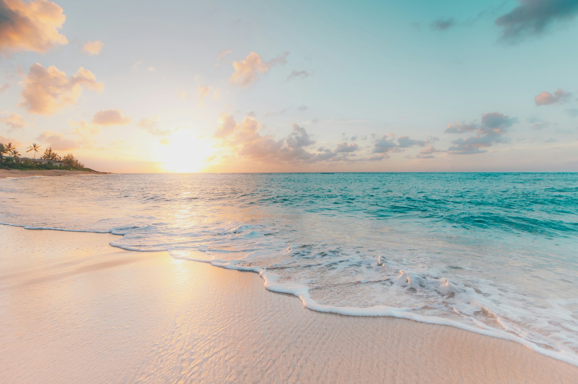 Caribbean beach at sunset with turquoise water and white sand